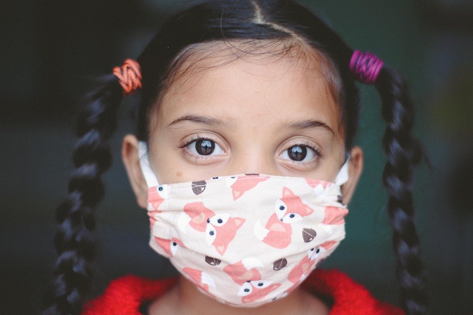 young girl wearing a mask
